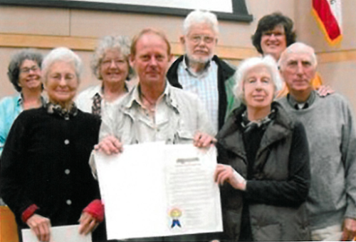 SMP receives Gold Standard. Image of eight people with one of them holding up the Gold Standard Certificate.